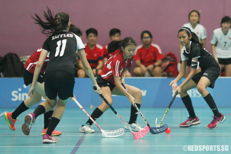 Olivia Ng (#18) controls the ball under pressure from RI players. (Photo © Chua Kai Yun/Red Sports)