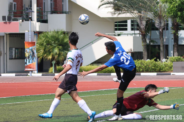 Eldon Foo (ACJC #20) drives pass SRJC"s goalkeeper and fires a goal. (Photo © Chua Kai Yun/Red Sports)