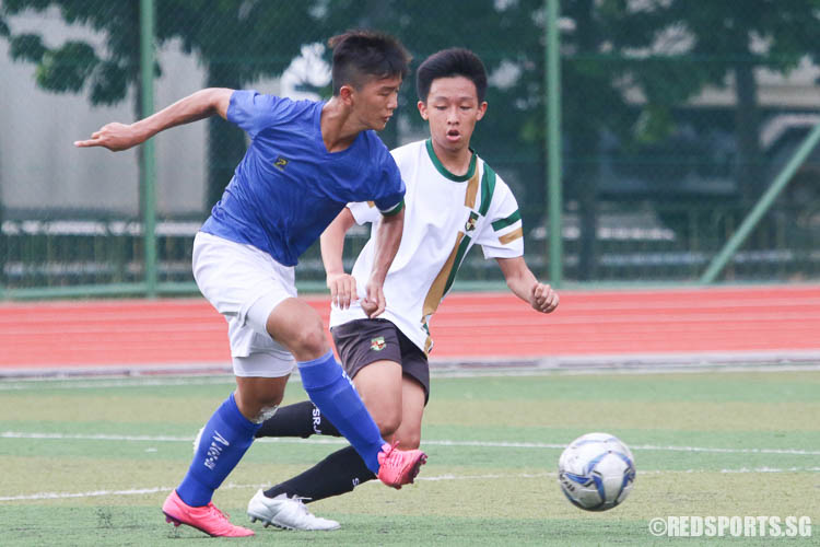 Carman Koh (DHS #7) kicks the ball against Nicholas (SRJC #18). (Photo © Chua Kai Yun/Red Sports)
