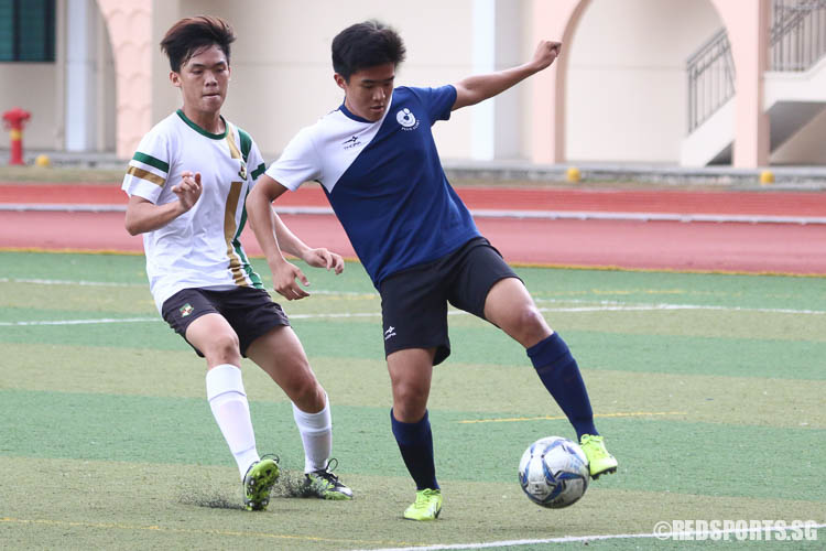 Nicholas Lee (JJC #16) controls the ball against Bryan Goh (SRJC #15). (Photo © Chua Kai Yun/Red Sports)