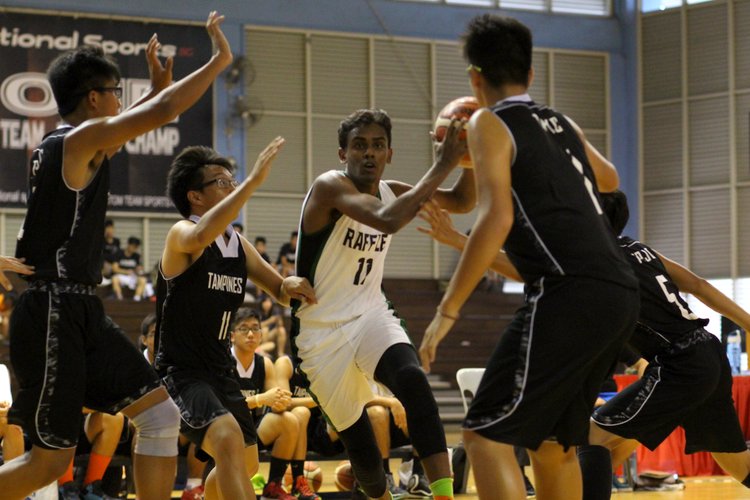 Vignesh Renagarajan (RI #11) driving in for a layup. He was the top scoere of the game, scoring 19 points. (Photo 1 © REDintern Adeline Lee)