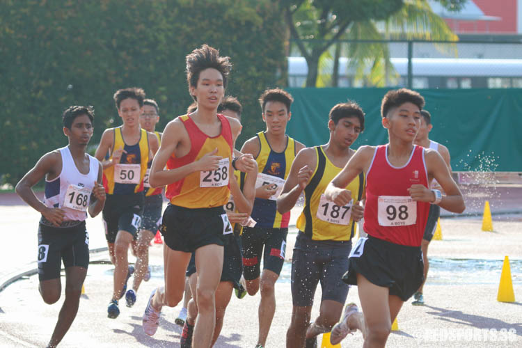 Athletes in action during the 3000m steeplechase event at the 57th National Inter-School Track & Field Championships. (Photo © Chua Kai Yun/Red Sports)