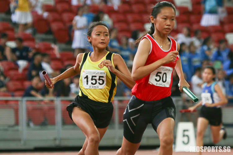 Vanessa Lee (#155) of VJC and Natalie Chu (#50) in action during the third leg of 4x400m relay. (Photo © Chua Kai Yun/Red Sports)