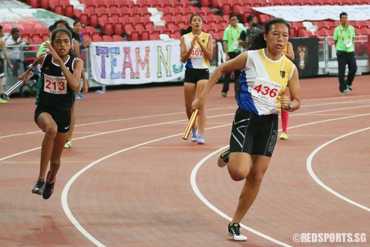 Tan Rou Ann (#436) of Nanyang Girls' and Grace Shani Anthony (#213) of Raffles Girls' in action at the third leg of the 4x100m relay. (Photo © Chua Kai Yun/Red Sports)