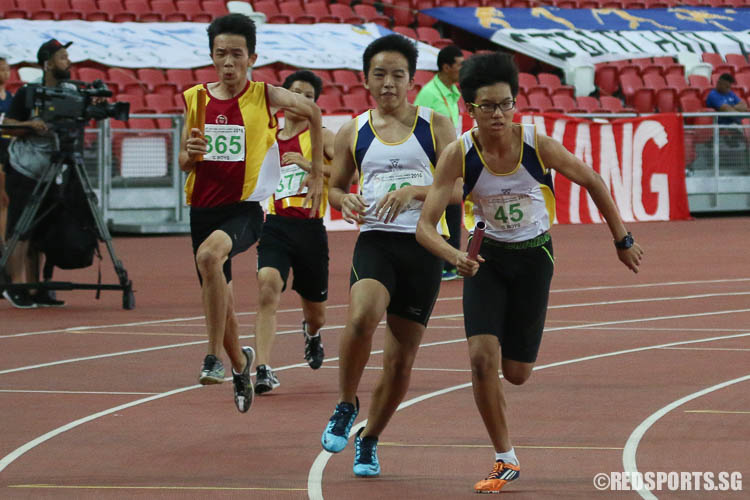 Glenn Chua (#365) of Victoria School and Lim Yong Xu (#45) of Catholic High starting the third leg of the 4x100m relay. (Photo © Chua Kai Yun/Red Sports)