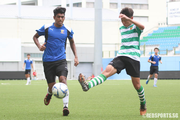 Ayyadarshan (ACJC #14) prepares to attack but Foo Jun Kit (#17) of RI kicks the ball out of play. (Photo © Chua Kai Yun/Red Sports)