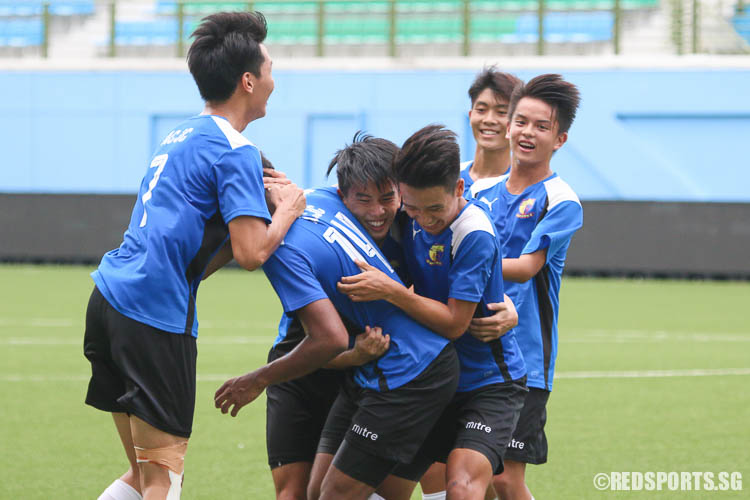 ACJC players celebrate Ayyadarshan's (#14) winning goal. With the help of his teammates in the six-yard box and an assist by Tan Xinwei (ACJC #12), Ayyadarshan comfortably slotted in the ball. (Photo © Chua Kai Yun/Red Sports)