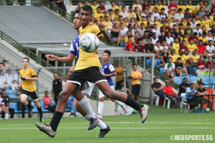 Ashwin Kalaichelvan (#4) of VJC reacts as his opponent kicks away his potential goal. (Photo © Chua Kai Yun/Red Sports)