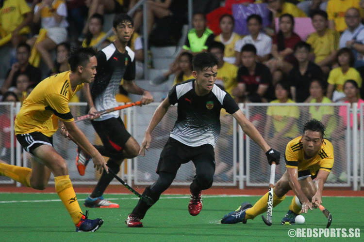 Yong How Zhi (#9) of RI attempts a pass but Ashwin Kalaichelvan (#4, left) of VJC plays the ball. (Photo © Chua Kai Yun/Red Sports)