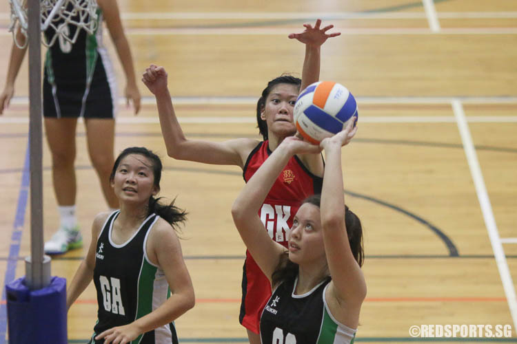 Low Yixuan (GK) of HCI attempts to block Isabelle Belanger (GS) from scoring. (Photo © Chua Kai Yun/Red Sports)