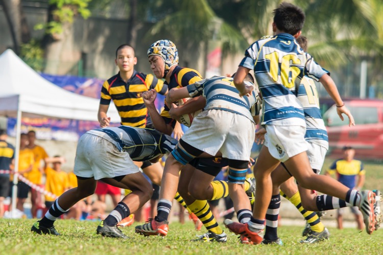 Dan Yuet Sean of ACS(I) braces himself for the tackle. (Photo © Low Sze Sen/Red Sports)