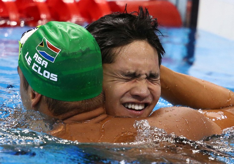 2016 Rio Olympics - Swimming - Final - Men's 100m Butterfly Final - Olympic Aquatics Stadium - Rio de Janeiro, Brazil - 12/08/2016. Joseph Schooling (SIN) of Singapore is congratulated by Chad Le Clos (RSA) of South Africa after winning. TSRIO2016   REUTERS/Marcos Brindicci