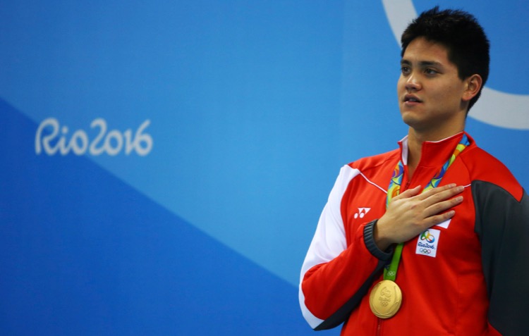 2016 Rio Olympics - Swimming - Victory Ceremony - Men's 100m Butterfly Victory Ceremony - Olympic Aquatics Stadium - Rio de Janeiro, Brazil - 12/08/2016. Joseph Schooling (SIN) of Singapore sings the national anthem. TSRIO2016 REUTERS/Michael Dalder