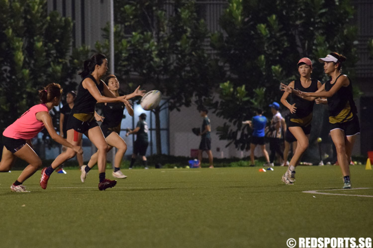 Clara Teo (SIM #17) passes the ball to teammate Magdalene Tan (SIM #15) to avoid a touch. (Photo 3 © Laura Lee/Red Sports)
