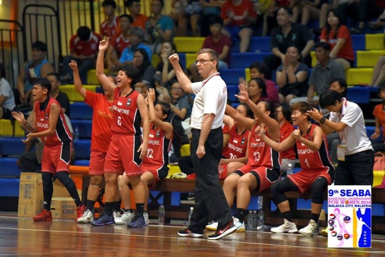 Captain Lim Jia Min (standing) celebrates the point together with the rest of the Singapore bench. Singapore beat Indonesia 71-68 to finish third at the SEABA Championship. (Photo 4: SEABA)