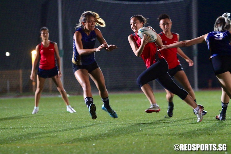 Temasek Poly (red) edged out Ngee Ann Poly (blue) 3-2 in their opening game of the POL-ITE Touch Football Championship. (Photo © Les Tan/Red Sports)