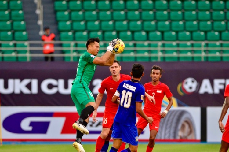 Hassan Sunny (#18) of Singapore gathers the ball and Teerasil Dangda (#10) of Thailand can only look on. (Photo: AFF Suzuki Cup website)