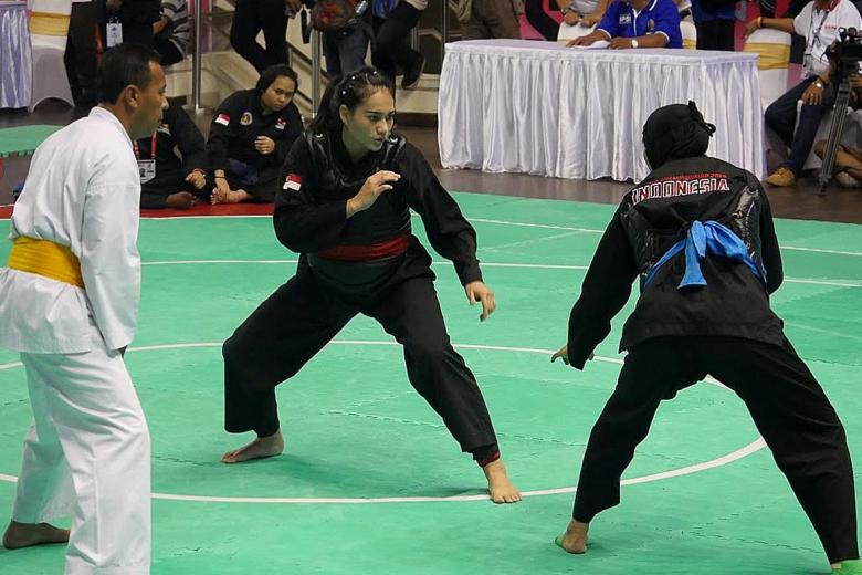 Singapore silat exponent Nurul Suhaila Mohd Saiful (with red sash) was defeated by reigning world champion Selly Andriani of Indonesia, in the semi-final of the World Pencak Silat Championships. (Photo Courtesy of PERSISI)