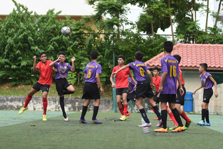 Muhammad Ilhan Mansiz Bin Mazlan (#5) of Serangoon Garden Secondary School challenges for a header against a NorthLight School player. (Photo 1 © Stefanus Ian/Red Sports)