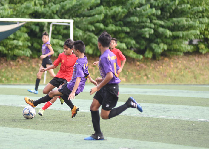 Mohamed Haikel B Mohamed Hazmi (#16) making a sliding tackle which was ruled to be a foul leading up the penalty for Serangoon Garden Secondary School. (Photo 1 © Stefanus Ian/Red Sports)