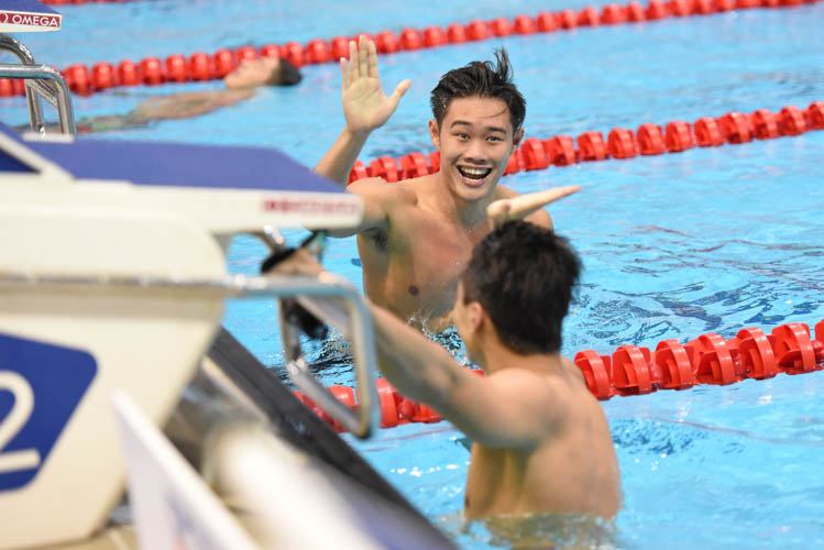 Teong Tzen Wei high fiving Dylan Koo  after clocking in 24.60 at the men's 50m butterfly final to clinch third on the first day of the 13th Singapore National Swimming Championship. (Photo © Stefanus Ian/Red Sports)