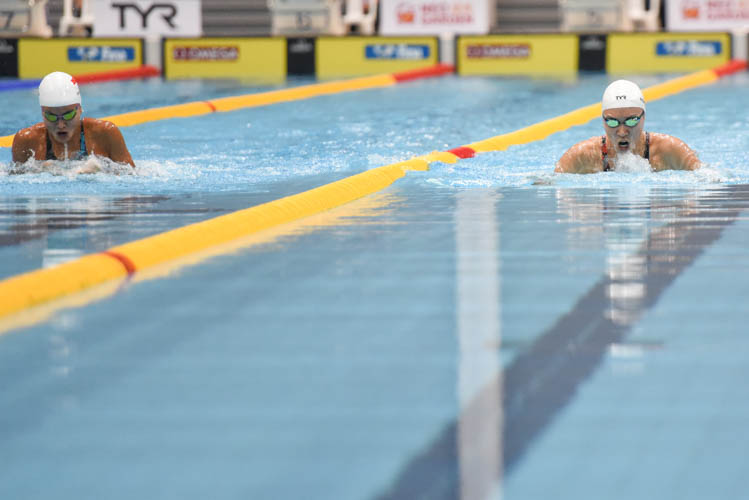 Roanne Ho (right) holding off Vanessa Evato of Indonesia (left) during the Women's 50m Breaststroke final on the third day of the 13th Singapore National Swimming Championship. (Photo © Stefanus Ian/Red Sports)