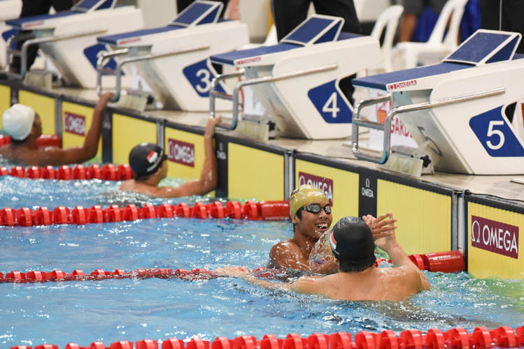 Aflah Fadlan Perwira shaking hands with Pang Shen Jun after the latter finished first in the Men's 400m Freestyle final on the third day of the 13th Singapore National Swimming Championship. (Photo © Stefanus Ian/Red Sports)