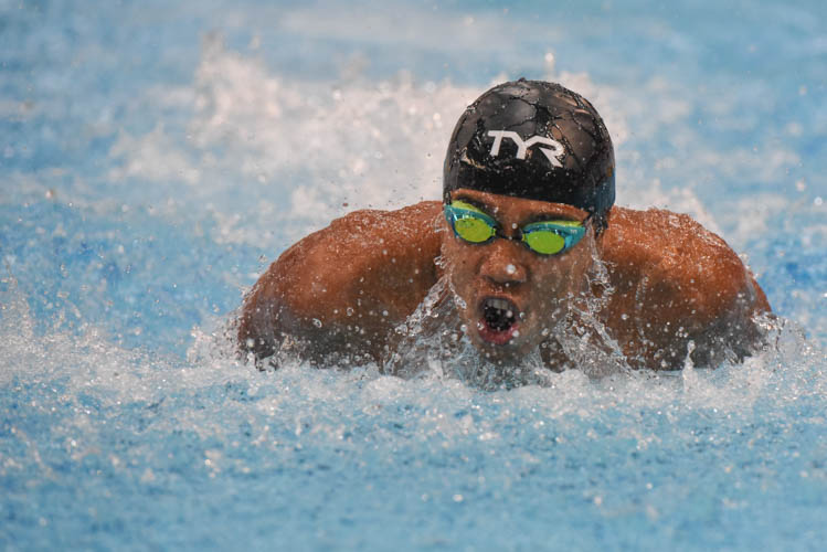 Triady Fauzy Sidiq glancing sideways as he finished first in the Men's 100m Butterfly final on the third day of the 13th Singapore National Swimming Championship. (Photo © Stefanus Ian/Red Sports)