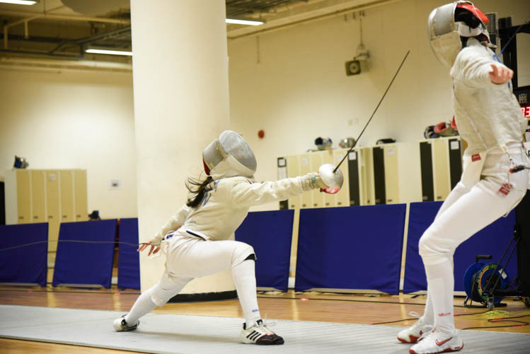 Heidi Loo making an attacking move against Jean Koh in the final of the girls' sabre event. (Photo © Stefanus Ian/Red Sports)