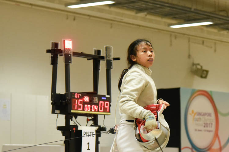 Heidi Loo reacting after beating Jean Koh in the final bout of the girls' sabre event. (Photo © Stefanus Ian/Red Sports)
