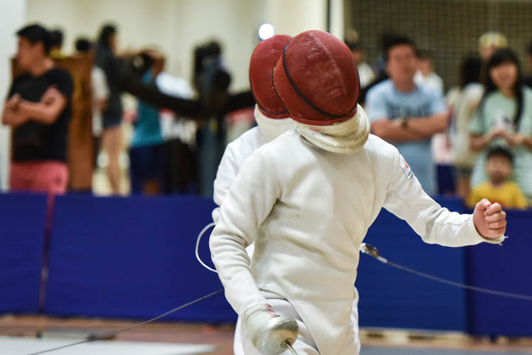 Ryan Tan of Singapore Sports School celebrating after scoring a touch during a bout in the boys' individual epee category on the final day of the fencing competition at the Singapore Youth Olympics Festival. (Photo © Stefanus Ian/Red Sports)
