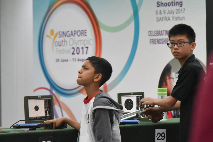 Muhammad Sameer bin Mustaffa reacting after a shot during the Air Pistol Men's Y13 category competition, he came in seventh place with a score of 471. (Photo © Stefanus Ian/Red Sports)