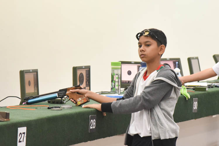 Muhammad Sameer bin Mustaffa preparing himself before a shot during the Air Pistol Men's Y13 category competition, he came in seventh place with a score of 471. (Photo © Stefanus Ian/Red Sports)