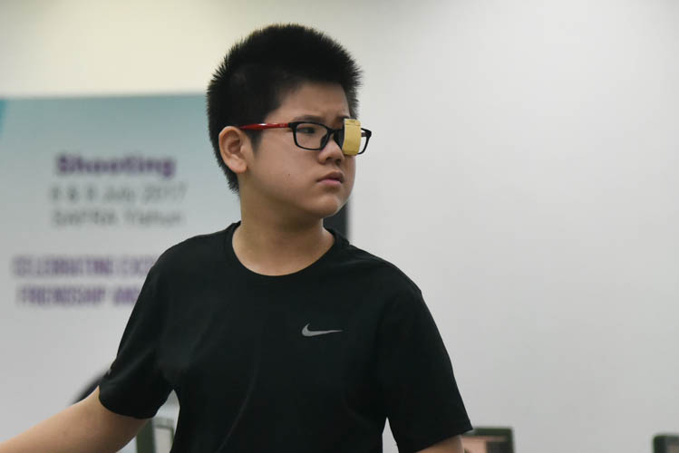 Hang Zizhou of St Hilda's Primary School reacting after his last shot was unable to help him come in first during the Air Pistol Men's Y13 category competition, he came in second with a score of 506. (Photo ©  Stefanus Ian/Red Sports)