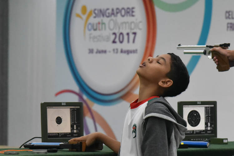 Muhammad Sameer bin Mustaffa reacting after a shot during the Air Pistol Men's Y13 category competition, he came in seventh place with a score of 471. (Photo © Stefanus Ian/Red Sports)