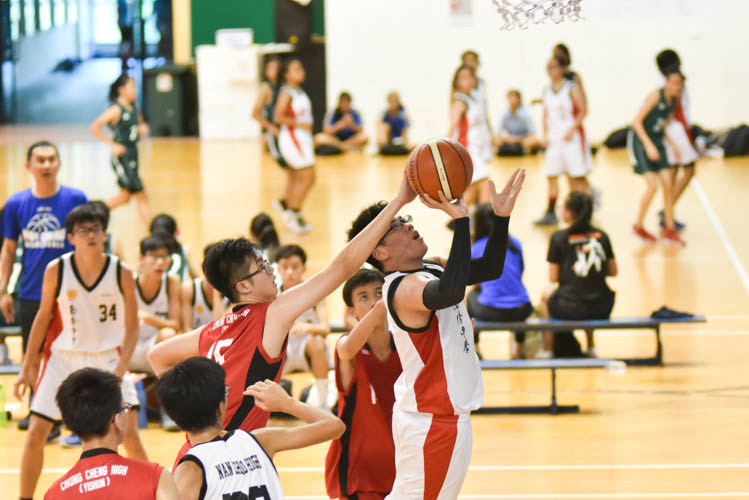 Ryan Lee (CCH #15) blocking Wong Jun Xi's (NCH #25) shot during the North Zone B Division basketball match between Chung Cheng High and Nan Chiau High School. (Photo © Stefanus Ian/Red Sports)