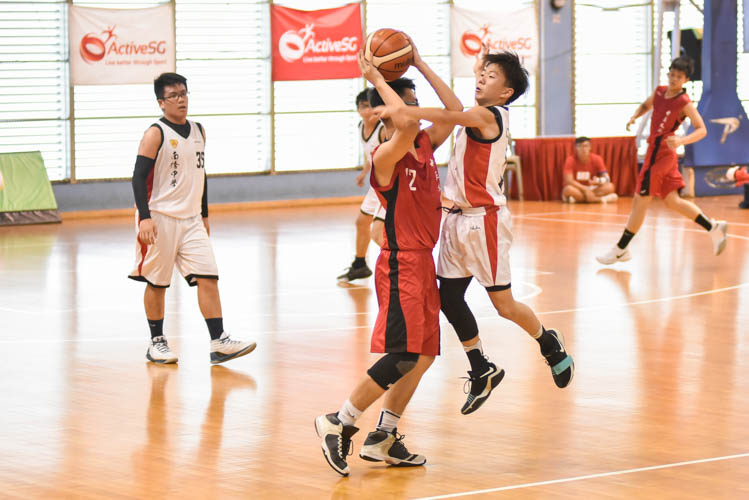 Lin Rubin (CCH #12) looking to pass as Bryan Ong (NCH #17) attempts to block during the North Zone B Division basketball match between Chung Cheng High (Yishun) and Nan Chiau High School. (Photo © Stefanus Ian/Red Sports)