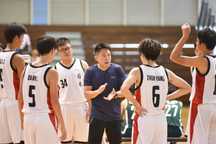 Hougang secondary school having a team talk during a timeout in their North Zone B Division basketball match between Hougang secondary and Woodgrove secondary. (Photo  © Stefanus Ian/Red Sports)