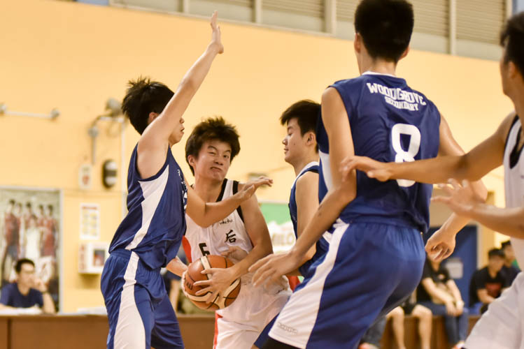 Zhun Yang (HG #6) attempting to dribble through the Woodgrove's defence during the North Zone B Division basketball match between Hougang secondary and Woodgrove secondary. (Photo  © Stefanus Ian/Red Sports)