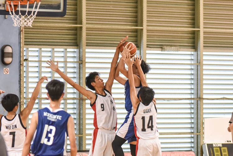 Nigel (HG #9) blocking a shot during the North Zone B Division basketball match between Hougang secondary and Woodgrove secondary. (Photo  © Stefanus Ian/Red Sports)