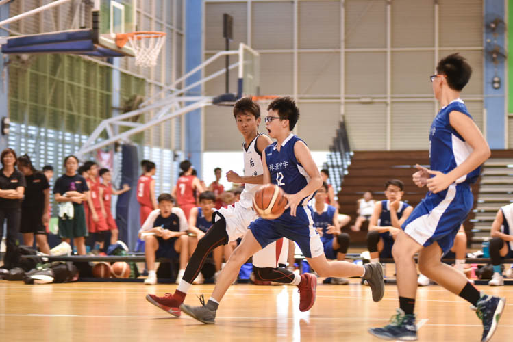Neo Zhen Quan (WG #12) driving to the basket during the North Zone B Division basketball match between Hougang secondary and Woodgrove secondary. (Photo  © Stefanus Ian/Red Sports)