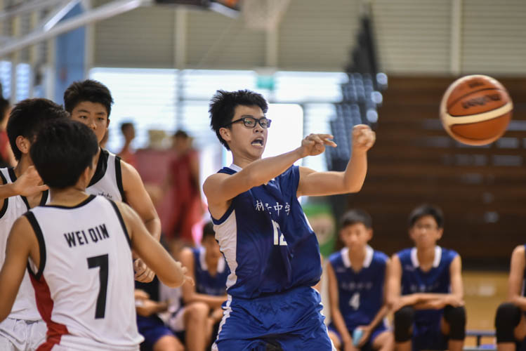 Neo Zhen Quan (WG #12) making a pass during the North Zone B Division basketball match between Hougang secondary and Woodgrove secondary. (Photo  © Stefanus Ian/Red Sports)