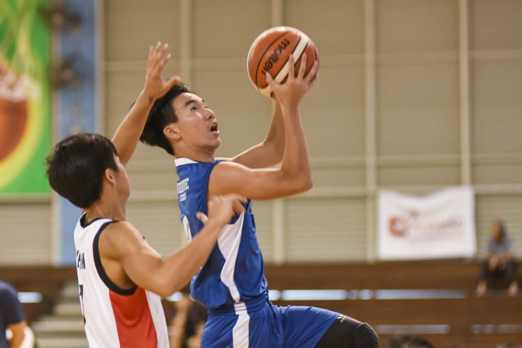 Teo Yung Juen (WG #13) attempting a lay up during the North Zone B Division basketball match between Hougang secondary and Woodgrove secondary. (Photo  © Stefanus Ian/Red Sports)