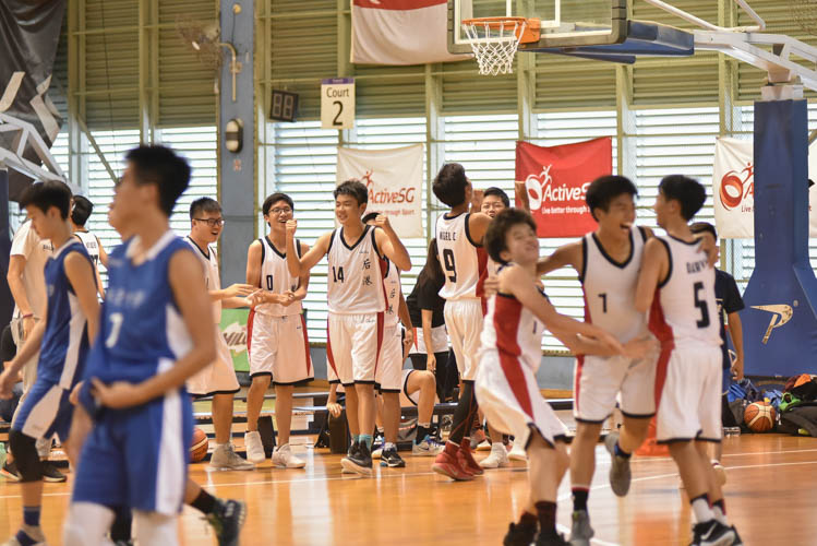 Hougang secondary school players celebrating their victory over Woodgrove secondary school as the final buzzer rang during their first round match in the North Zone B Division basketball. (Photo © Stefanus Ian/Red Sports)
