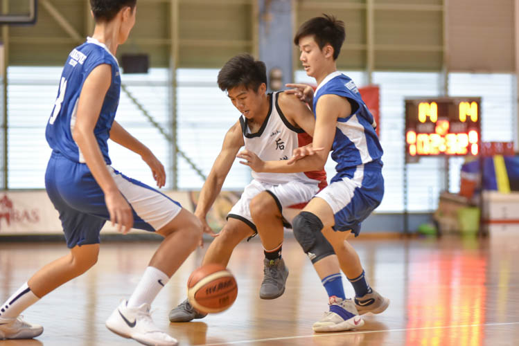 Wei Qin (HG #7) attempting to dribble past Woodgrove's defence during the North Zone B Division basketball match between Hougang secondary and Woodgrove secondary. (Photo  © Stefanus Ian/Red Sports)