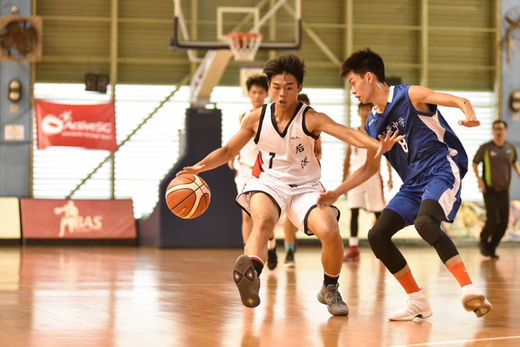 Wei Qin (HG #7) attempting to dribble past Sky Chong (WG #8) during the North Zone B Division basketball match between Hougang secondary and Woodgrove secondary. (Photo  © Stefanus Ian/Red Sports)