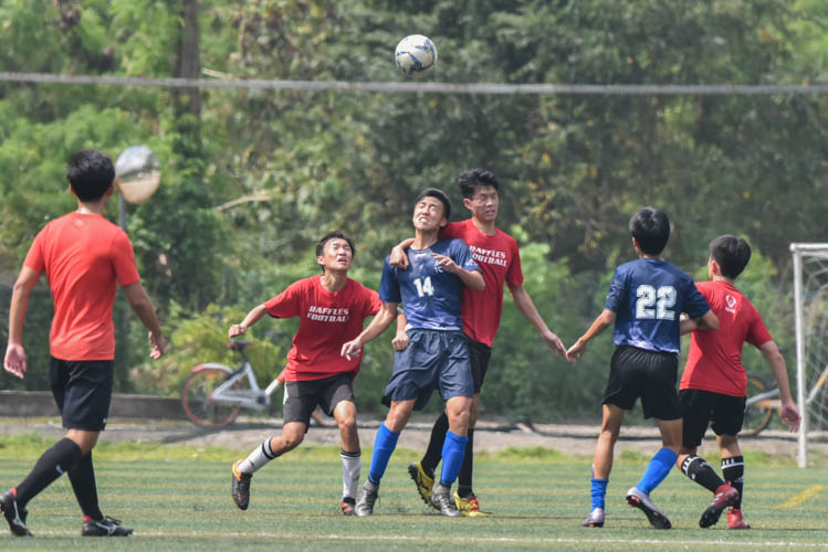 Tan Wei Jun (RVHS #14) challenging for a header during a NYSI JC League match between Raffles Institution and River Valley High School. (Photo © Stefanus Ian/Red Sports)