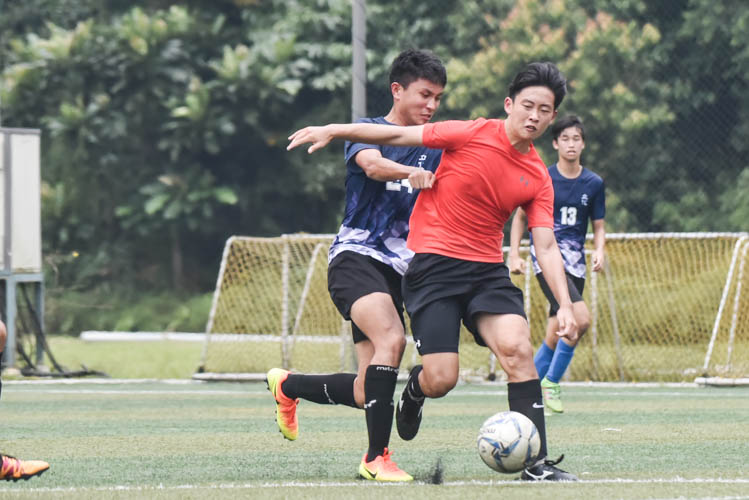 A Raffles Institution player (in red) dribbling the ball during a NYSI JC League match between Raffles Institution and River Valley High School. (Photo © Stefanus Ian/Red Sports)
