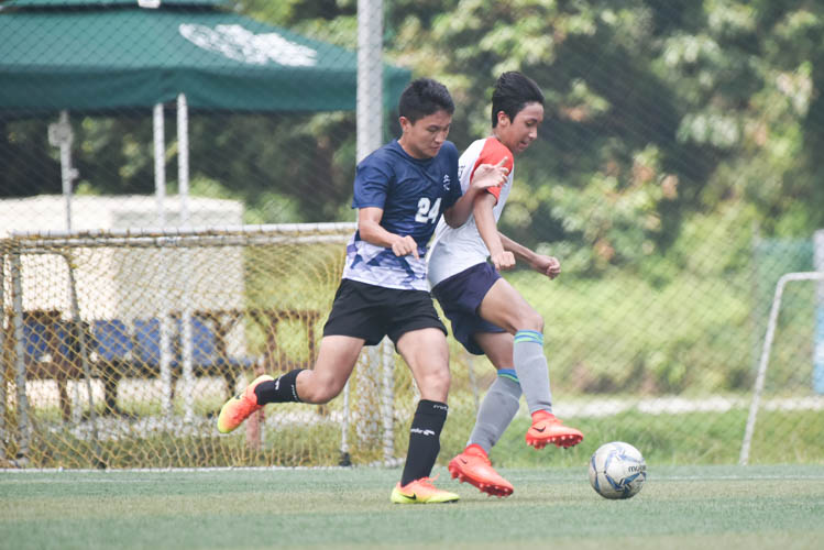 Chen Zuo Hui (RVHS #24) making a tackle during a NYSI JC League match between Raffles Institution and River Valley High School. (Photo © Stefanus Ian/Red Sports)
