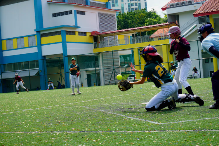 Crescent Girls' School's catcher, Abigail (#25) attempting to stop a wild pitch during the game of Crescent Girls' School  against Tanjong Katong Girls' School. (Photo 7 by © Pang Chin Yee /REDIntern)